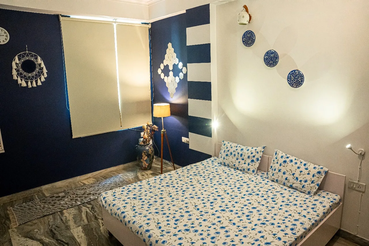 Comfortable blue and white homestay bedroom in Jaipur